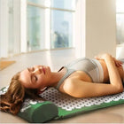 Woman lying relaxed on the acupressure mat and pillow set