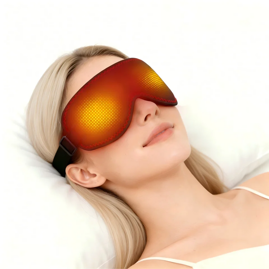 Woman relaxing in bed wearing the heated compression eye mask