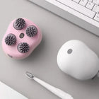 Electric scalp massager shown on a bathroom counter